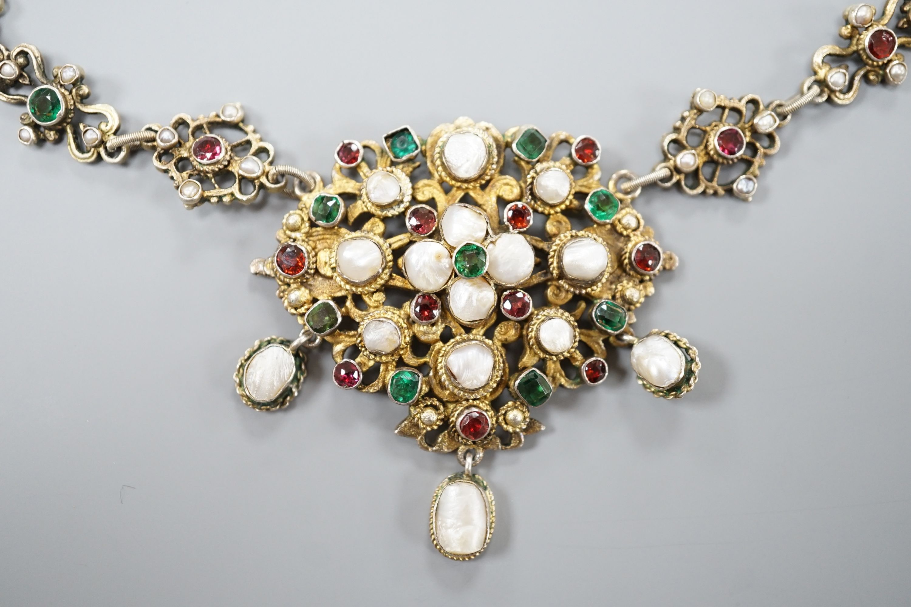 An ornate 19th century Austro-Hungarian gilt white metal, baroque pearl, paste and gem set drop necklace, 46cm, maker's mark WH or WM.